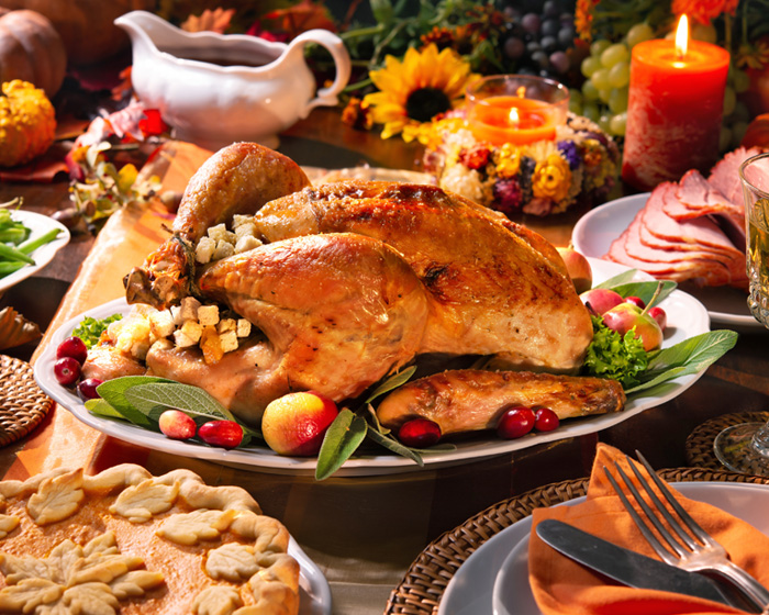 Thanksgiving dinner table with cooked turkey and pie